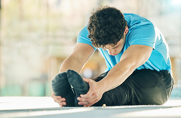 Image showing Exercise, fitness and man stretching legs in gym for health, wellness and flexibility. Sports, training and male athlete stretch, workout or warm up for exercising, running or cardio jog for strength