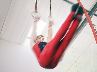 Image showing Gymnastics, ring and sports with man in stadium and speed for fitness, workout or health challenge. Wellness, exercise and training with athlete lifting in gym arena for strong, power and motion blur