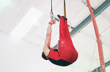 Image showing Gymnastics, ring and lifting with man in gym and focus for sports, workout or health challenge. Wellness, exercise and fitness with athlete training in stadium arena for strong, power and motivation