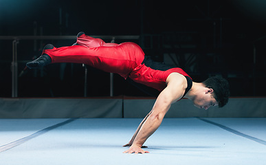 Image showing Gymnast, handstand and man on gym floor for training, balance and wellness with muscle, strong body and night. Gymnastics, athlete and exercise in studio for competition, goals and fitness for sport