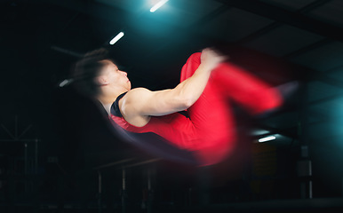 Image showing Training, gymnastics and jump with man in stadium for sports, speed and motion blur. Workout, action and challenge with flexible athlete in gym arena for performance, exercise and fitness health