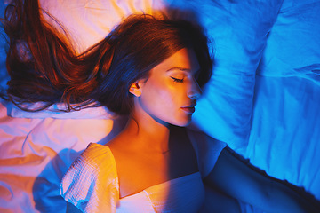 Image showing Sleeping beauty, lights and woman with sleep and creative neon lighting. Resting, face and model glow and feeling relax and calm on a bed pillow with aesthetic profile in a bedroom bed at home