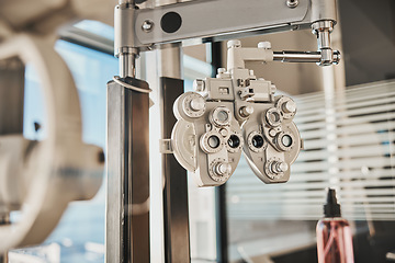 Image showing Vision, optometry and healthcare in an optician office with an ophthalmic phoropter machine for testing. Hospital, medical and eye health with test equipment in an empty room at the optometrist