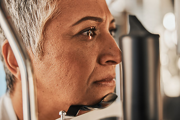 Image showing Laser, vision or senior woman in eye exam for eyesight at optometrist office in assessment or consultation. Face of mature female customer testing or checking iris, glaucoma or retina visual health