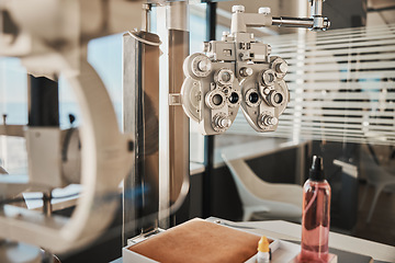 Image showing Vision, optometry and eye health in an optician office with an ophthalmic phoropter machine for testing. Hospital, medical and healthcare with test equipment in an empty room at the optometrist