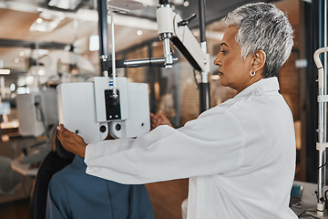 Image showing Eye exam, optometry and optometrist woman for vision consultation, medical or healthcare lens expert. Eyes check or consulting client, person or patient with professional doctor and phoropter machine