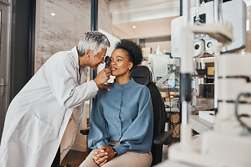 Image showing Doctor, vision or black woman in eye exam consultation or assessment for eyesight at optometrist office. Mature or senior optician helping a customer testing or checking iris or retina visual health