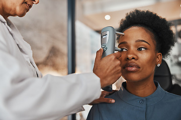Image showing Face, eye exam or black woman consulting doctor for eyesight at optometrist or ophthalmologist. African customer testing vision with hands of optician helping or testing iris or retina visual health