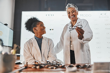 Image showing Glasses, optometrist teamwork and women in shop or store for frames, eyewear or eye care spectacles. Ophthalmology, vision and happy senior optician laughing at funny joke or comedy with black woman.