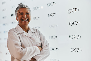 Image showing Portrait, woman and smile of optician with arms crossed in shop or store for glasses, eyewear or spectacles. Ophthalmology, vision and laughing, proud and confident senior female medical optometrist.