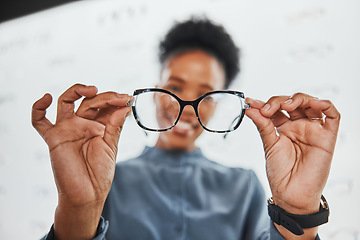 Image showing Glasses, black woman hands and customer with store worker at optician clinic looking at lens. Consulting, smile and eyewear shopping in a frame shop for vision test and prescription exam for eyes