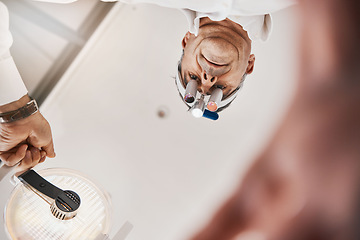 Image showing Optometry, below and a doctor with a light for a checkup, eye and vision care. Surgery, health and optometrist with equipment, lighting and tools for an exam on eyes, eyesight and optical correction