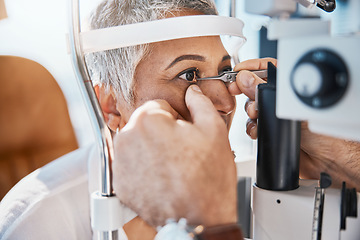 Image showing Help, hands or senior woman in eye exam with doctor eyesight at optometrist or ophthalmologist. Optician helping a mature customer testing or checking vision, iris or retina visual health in office