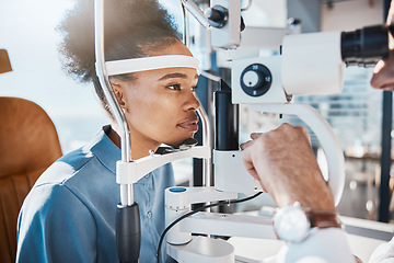 Image showing Eye exam or black woman consulting doctor for eyesight at optometrist or ophthalmologist. Face of African customer testing vision with optician helping or testing iris or retina visual health