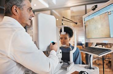 Image showing Computer, eye exam or black woman consulting doctor to help with eyesight at optometrist or ophthalmologist. African customer testing vision with mature optician to check iris or retina visual health