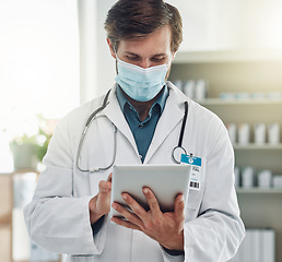 Image showing Healthcare, tablet and doctor with mask for medical care, wellness and research analysis in hospital. Covid, insurance and health worker on digital tech for internet, patient data and telehealth app