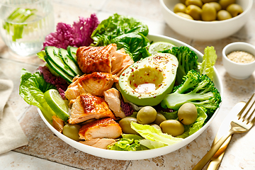 Image showing Salmon avocado bowl with broccoli, olives and fresh salad. Healthy food, keto diet