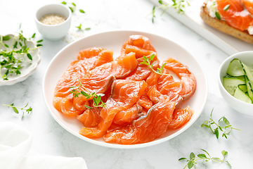 Image showing Salted salmon sliced on plate on a white background