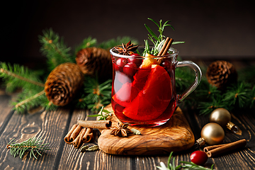 Image showing Christmas mulled wine with cranberry, orange, cinnamon, anise and rosemary. Traditional hot drink or beverage, festive Xmas or New Year winter cocktail