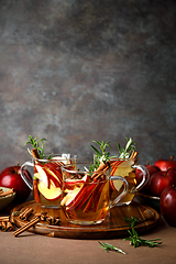 Image showing Christmas mulled apple cider with cinnamon, anise and rosemary. Traditional hot drink or beverage, festive Xmas or New Year winter cocktail