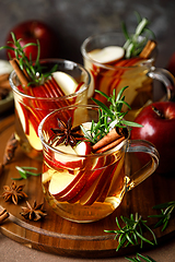 Image showing Christmas mulled apple cider with cinnamon, anise and rosemary. Traditional hot drink or beverage, festive Xmas or New Year winter cocktail