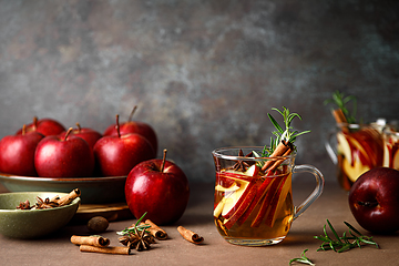 Image showing Christmas mulled apple cider with cinnamon, anise and rosemary. Traditional hot drink or beverage, festive Xmas or New Year winter cocktail