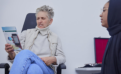 Image showing Eye test, optometry and senior woman reading document for examination in hospital. Vision, ophthalmology and elderly female squinting or strain with poor eyesight while studying data or information.