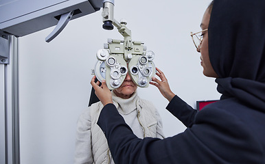Image showing Eye exam, optometry consultation and woman test for medical, healthcare and vision with muslim expert. Eyes check or consulting of senior person and professional optometrist with phoropter machine