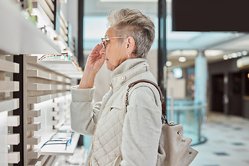 Image showing Fashion, retail and glasses with a senior woman customer in an eyewear store for new frame spectacles. Healthcare, vision and shopping with a mature female consumer buying prescription lenses