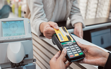 Image showing Hands, credit card and machine for payment, ecommerce or banking transaction at clinic or store. Hand of customer tapping debit in transact for purchase, electronic pay or POS at optometry shop