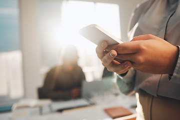 Image showing Business woman, hands typing and teamwork meeting with a female employee on a mobile app. Office, lens flare and online chat of a financial analytics worker on a cellphone reading website content