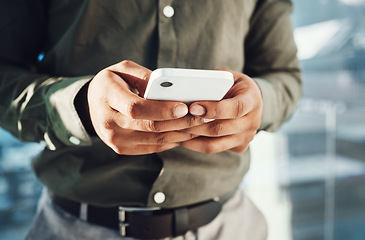 Image showing Hands, business phone and typing in office, texting or social media in company workplace. Technology, cellphone or black man or male entrepreneur with mobile smartphone for networking or web browsing