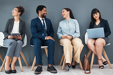 Image showing Talking, recruitment and business people in waiting room for interview with human resources. Hr hiring, job and group of candidates, men and women laughing with devices in company for employment.