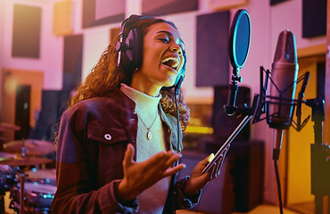 Image showing Tablet, music and woman singing in a studio for radio, song production and rehearsal. Creative, voice and a singer making a record, track or recording a musical sound as a professional artist