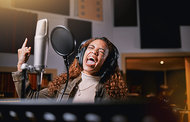 Image showing Music, singing and radio with a black woman celebrity at her record label to sing a song for her new album. Creative, art and performance with a female singer streaming live in a recording studio