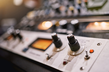 Image showing Music, studio and equipment in an empty booth for recording or live streaming a broadcast on the radio closeup. Media, technology and production with an electronic soundboard for mixing audio