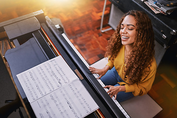 Image showing Woman, singing and playing piano with music notes and a smile in home for musician talent and keys. Young person, artist or singer happy about performance and sound of voice and instrument