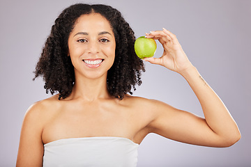 Image showing Apple, fruit and portrait of a black woman holding wellness food for detox and weight loss. Skincare, beauty and young model in a isolated studio for nutrition and vitamin diet for skin glow