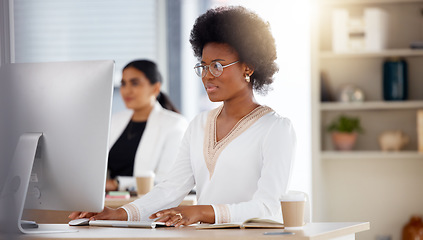 Image showing Serious black woman, computer and working in focus checking corporate database or finance at office desk. African American female sitting by desktop PC for email or communication at the workplace