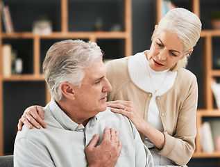 Image showing Heart attack, woman stress and senior couple at home with cardiology problem or stroke. House, marriage and retirement of a man with emergency and health issue in a living room with female support