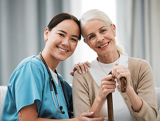 Image showing Nurse, senior woman and sofa for portrait, walking stick and smile together with happiness, chat and care. Elderly patient, asian doctor and couch with helping hand, happy and connection for support