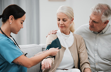 Image showing Blood pressure, senior couple and nurse on a nursing home sofa for health and wellness check. Healthcare, doctor and living room consultation for medical test in retirement on a lounge couch