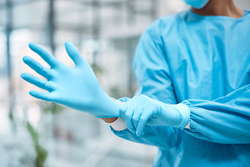 Image showing Medical gloves, medical gear and doctor hand in a wellness and health clinic ready for surgery. Safety, research and laboratory hygiene of a healthcare and nurse employee with blurred background