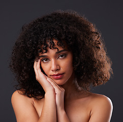 Image showing Portrait, natural and beauty by black woman in studio for hair, treatment and body care on black background. Face, girl and curly afro model relax with luxury, soft and glowing skin while isolated