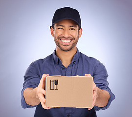 Image showing Portrait, man and courier with box, happiness and shipping with logistics against blue studio background. Face, male employee and delivery person with package, parcel and mail distribution service