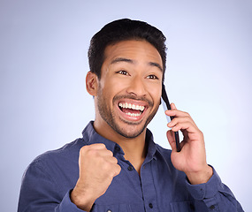 Image showing Happy, excited and Asian man on a phone call for promotion isolated on a purple background in studio. Winning, communication and businessman on a conversation about success, good news and achievement