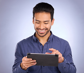 Image showing Happy business man on tablet isolated on studio background for stock market research with online app. Happy asian person, worker or entrepreneur on digital technology for profit, sales and fintech