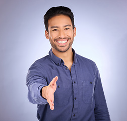 Image showing Hand shake, welcome and portrait of a business man with happiness from deal agreement. Isolated, blue background and studio with a young man ready for shaking hands for onboarding or yes hand sign