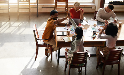 Image showing High five, creative startup and people success in project teamwork, collaboration or planning ideas at office table. Diversity employees, digital graphic design and hands together for career support