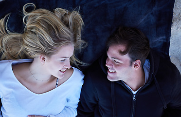 Image showing Couple, beach and relax young people on a towel with love, care and bonding outdoor. From above, happy and vacation fun of a woman and man together with a smile on holiday travel by the sea sand